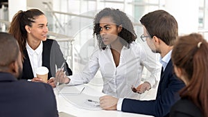 Business team listen to african businesswoman coach speaking at training