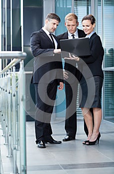 Business team looking at laptop