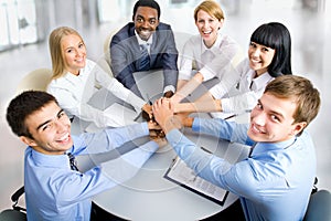 Business team making pile of hands on working place