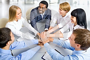 Business team making pile of hands on working place