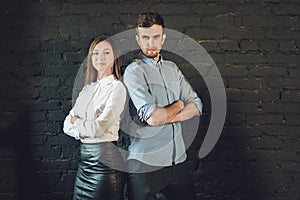 business team male and female formed of young businessmen standing over a dark background