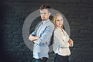 business team male and female formed of young businessmen standing over a dark background