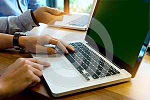 Business team man and woman work with laptop on wood table