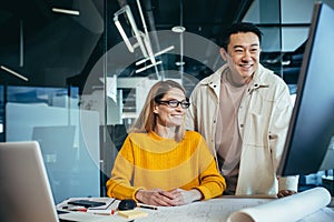 team man and woman, working together, happy and cheerful, looking at a computer monitor, consulting, got a good result of