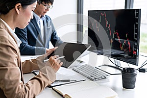 Business team partner working with computer, laptop, discussion and analyzing graph stock market trading with stock chart data