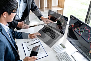 Business team partner working with computer, laptop, discussion and analyzing graph stock market trading with stock chart data