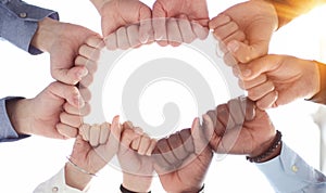 Business team or partners put fists in circle as concept of motivating engaging teambuilding activity