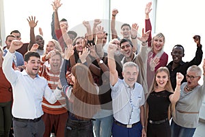 Business team raising their hands up to celebrate victory