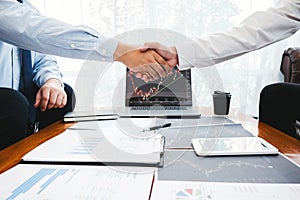 Business Team shaking hands with Investment Entrepreneur Trading discussing and analysis graph stock market trading,stock chart