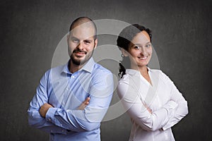 Business Team standing in front of a grey blackboard background