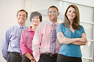 Business team standing indoors smiling