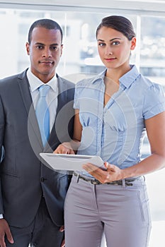 Business team with tablet pc smiling at camera