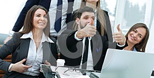 Business team with thumbs up and vote for a decision near the desktop