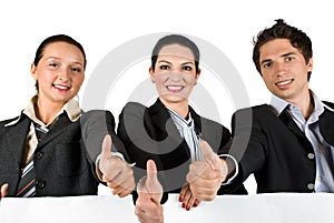 Business team with thumbs up and white sign