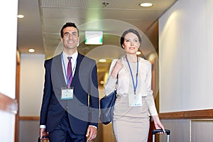 Business team with travel bags at hotel corridor