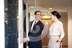 Business team with travel bags at hotel elevator
