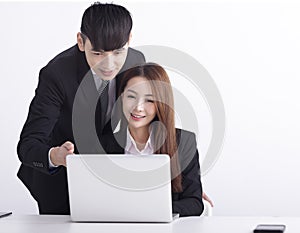 Business team using laptop and working together in office