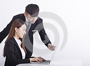 Business team using laptop and working together in office