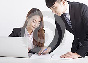 Business team using laptop and working together in office