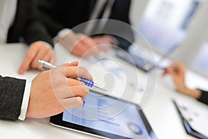 Business team using tablet computer to work with financial data