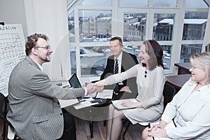 Business team welcomes the business partner in a business meetin