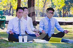 Business and team work.They are meditate in public park.