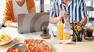 Business team workers discussing work and prepare pizza and potato chips to sharing meal at lunch break for good relations in