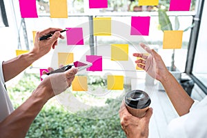 Business team working marketing growth on financial document graph report statistics, using post it notes in glass wall to writing