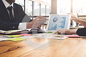 Business team working on tablet and documents at workplace wooden desk in office. Business Team Corporate Organization Working Co