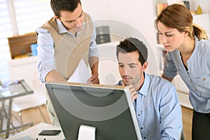 Business team working together with computer