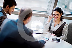Business team working together to achieve better results. Head of a woman with glasses