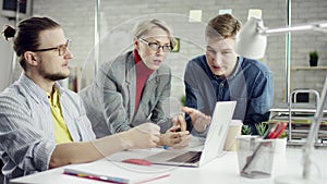 Business team of young disciplined people enjoying working together, millennials group talking having fun in cozy office