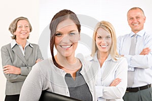 Business team young woman with mature colleagues
