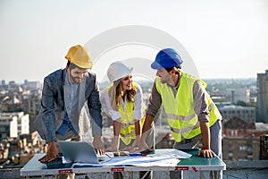 Business, teamwork and people concept. Group of engineers and architects on construction site