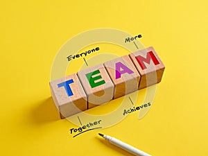 Business and teamwork synergy concept. The word Team on wooden cubes