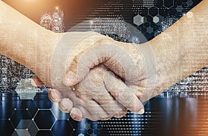 Business and technology concept. Double exposure of handshake wi