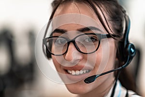 Business and technology concept - helpline female operator with headphones in call centre .Business woman with headsets