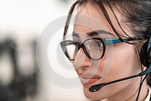 Business and technology concept - helpline female operator with headphones in call centre .Business woman with headsets