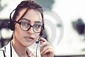 Business and technology concept - helpline female operator with headphones in call centre .Business woman with headsets