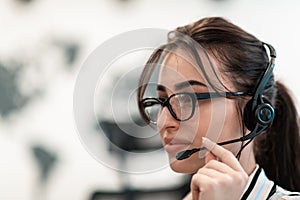 Business and technology concept - helpline female operator with headphones in call centre .Business woman with headsets