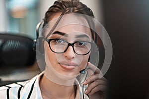 Business and technology concept - helpline female operator with headphones in call centre .Business woman with headsets