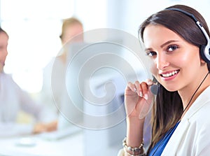 Business and technology concept - helpline operator with headphones in call centre