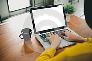 Digital lifestyle working outside office. Woman hands typing laptop computer with blank screen on table in coffee shop. photo