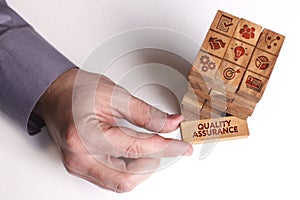 Business, Technology, Internet and network concept. Young businessman shows the word: Quality assurance photo