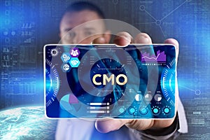 Business, Technology, Internet and network concept. Young businessman showing a word in a virtual tablet of the future: CMO photo