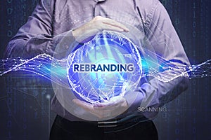 Business, Technology, Internet and network concept. Young businessman shows the word: Rebranding photo