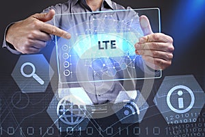 Business, Technology, Internet and network concept. Young businessman showing a word in a virtual tablet of the future: LTE