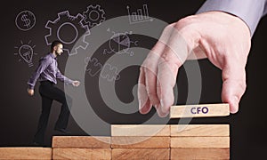 Business, Technology, Internet and network concept. Young businessman shows the word: CFO