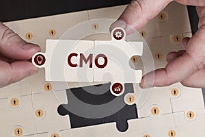 Business, Technology, Internet and network concept. Young businessman shows the word: CMO