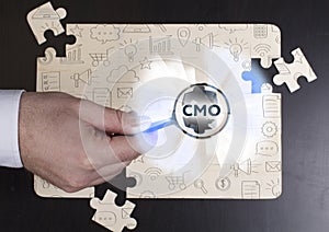 Business, Technology, Internet and network concept. Young businessman shows the word: CMO